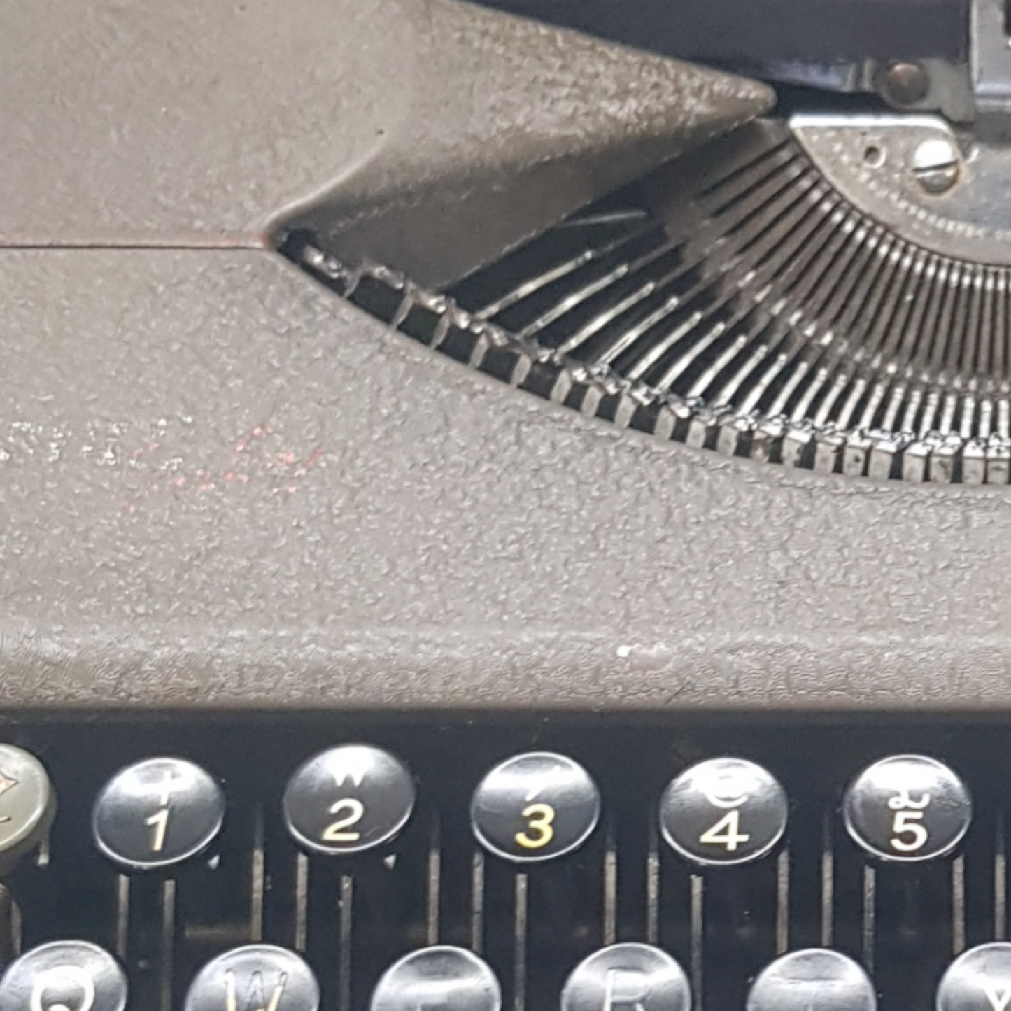 Image of Hermes Baby Old Typewriter. Portable Typewriter. Original Dark Grey. Swiss Made. Available with cover. Available from universaltypewritercompany.in