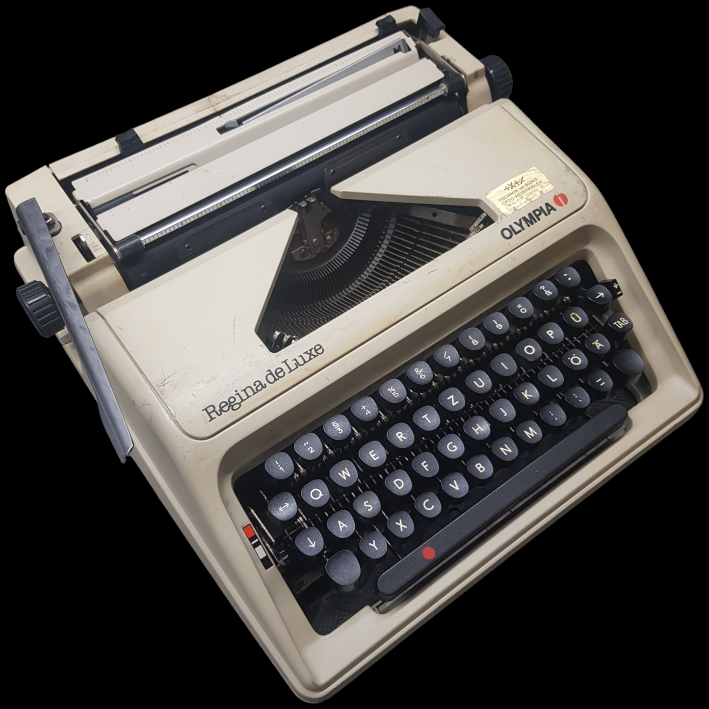 Image of Olympia Regina DLX Typewriter. A Midsize Portable Typewriter. Made in Germany. Fibre Body. Available from universaltypewritercompany.in.