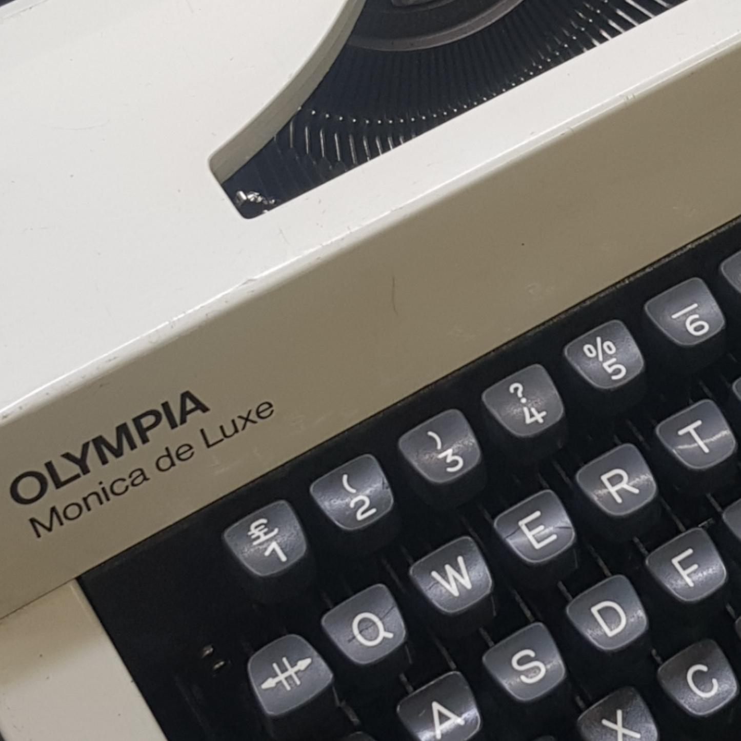 Image of Olympia Monica DLX Typewriter. A Midsize Portable Typewriter. Made in Germany. Fibre Body. Available from universaltypewritercompany.in.