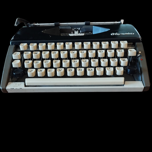 Image of Olympia Port SF DLX Typewriter. Available from universaltypewritercompany.in\